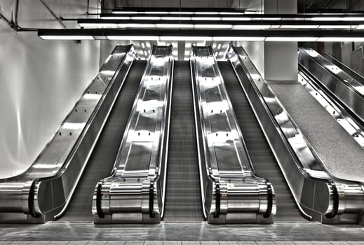 There is a long exposure picture using HDR technique. It show a bit of movement and motion. the stairs are blurry and there is no people in this scene. This was shot in the Montreal metro (subway).