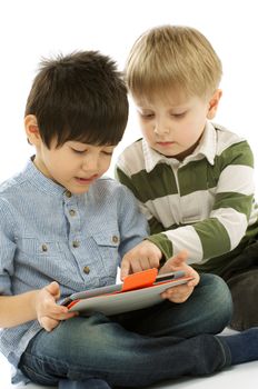 Two Little Boys Using Digital Tablet PC Together closeup on white background