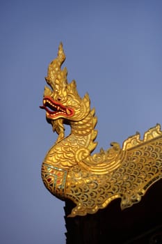 Thai golden dragon on a background of blue sky - decorative element architecture