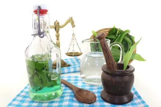 wild garlic tincture in a bottle with basket on light background