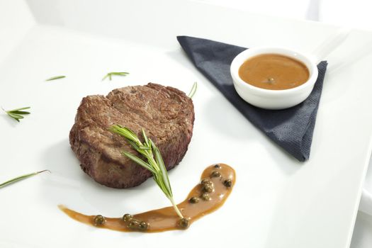 Beefsteak Tenderloin with the rosemary on the white plate