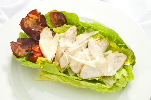 Salad Caesar with pieces of chicken and parmesan