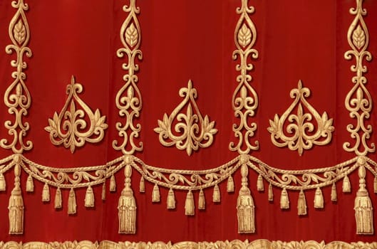 Theatrical red velvet curtain with gold pattern
