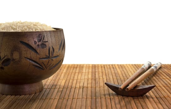 wooden bowl with rice and chopsticks