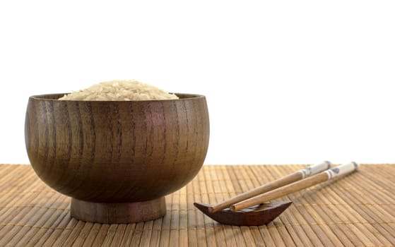wooden bowl with rice and chopsticks