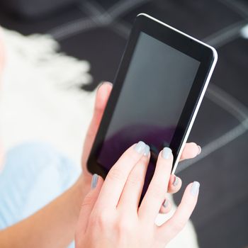 Hands holding and touching a tablet pc