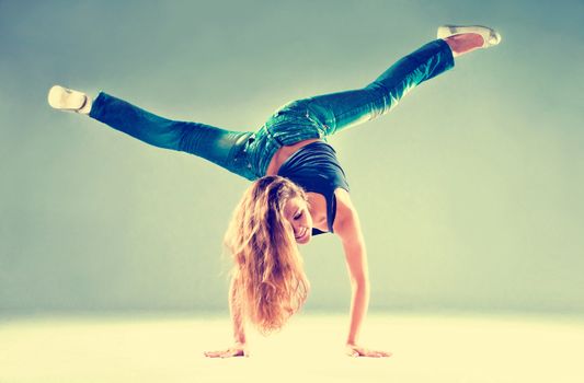 young and beautiful dancer posing in studio