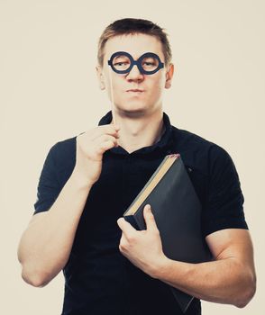 comical man with fake glasses and book