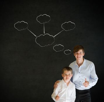 Thumbs up boy dressed up as business man with teacher man and strategy thought chalk clouds on blackboard background