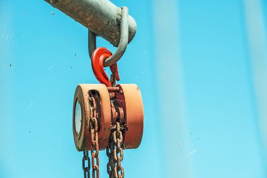 Strong used hoist in the sky with spider web and dead flies