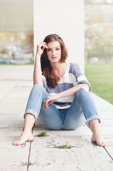 attractive young brunette woman barefoot in summertime outdoor