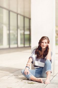 attractive young brunette woman barefoot in summertime outdoor