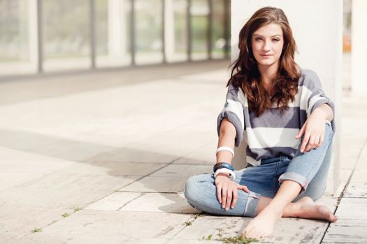 attractive young brunette woman barefoot in summertime outdoor