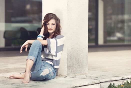 attractive young brunette woman barefoot in summertime outdoor