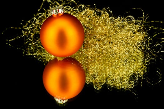 christmas decoration in orange and gold on black background