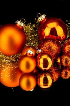 christmas decoration in orange and gold on black background