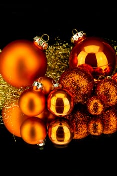 christmas decoration in orange and gold on black background