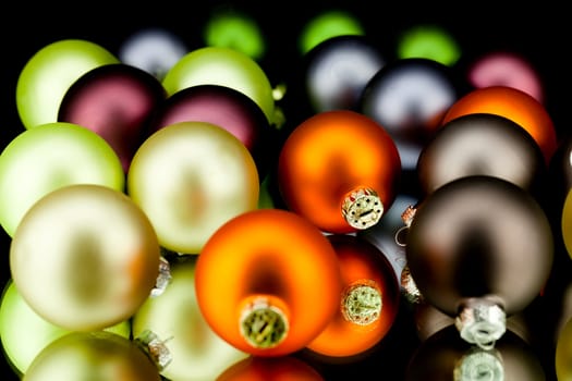 christmas decoration in gold lime green and mixed colours isolated on black background