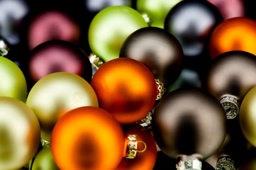 christmas decoration in gold lime green and mixed colours isolated on black background