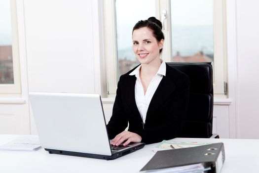 young successful business woman working on computer in office