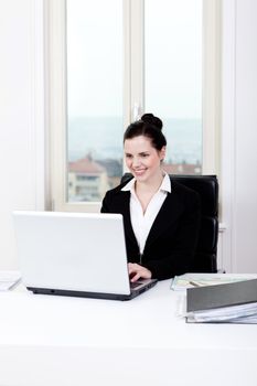young successful business woman working on computer in office