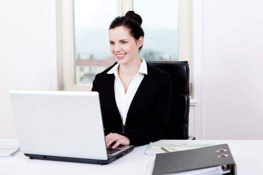 young successful business woman working on computer in office