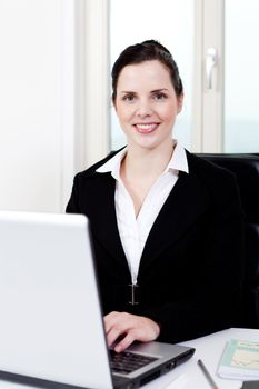 young successful business woman working on computer in office