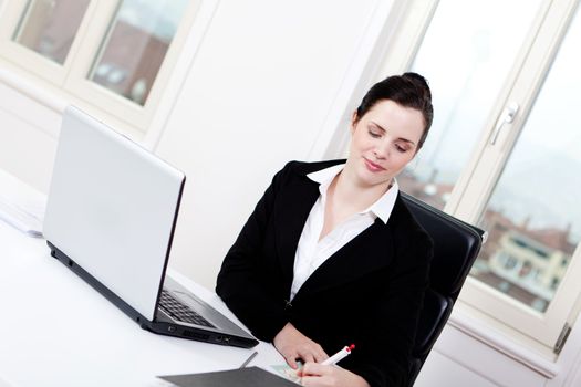 young successful business woman working on computer in office