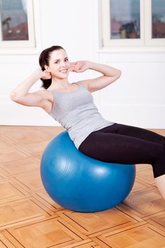 attractive young woman doing sit ups at home sport workout