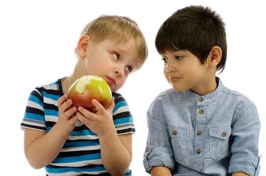One Little Boy Eating an Apple and Another Little Boy Wants to Eat an Apple too