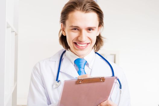 portrait of a doctor with a clipboard takes notes