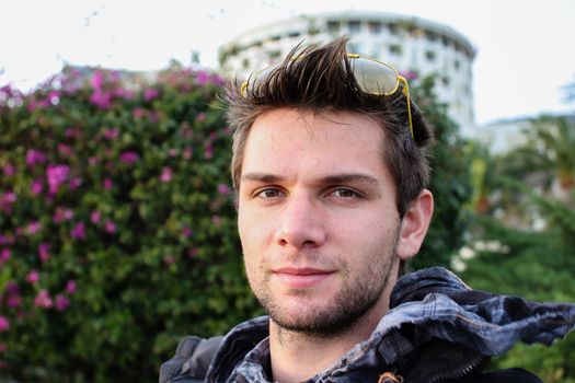 Young Man Sitting Outdoors And Thinking