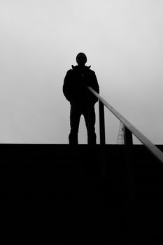 Silhouette of a man with a grey background