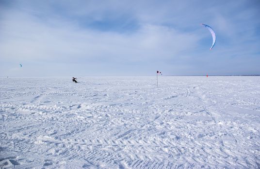 Winter kite skiing on the frozen river
