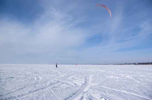 Winter kite skiing on the frozen river