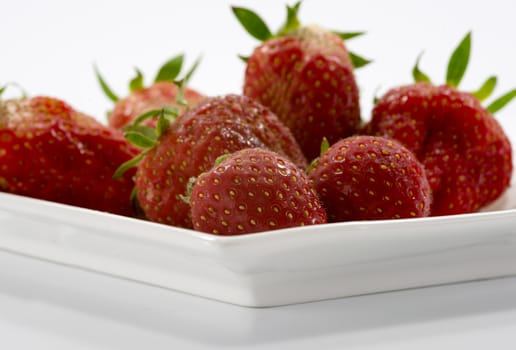 fresh strawberries on white plate