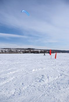 Winter kite skiing on the frozen river