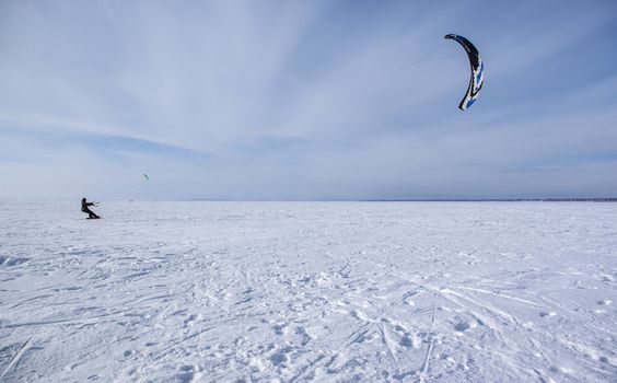 Winter kite skiing on the frozen river