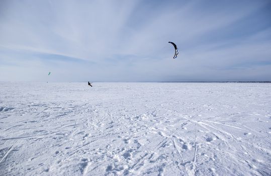 Winter kite skiing on the frozen river