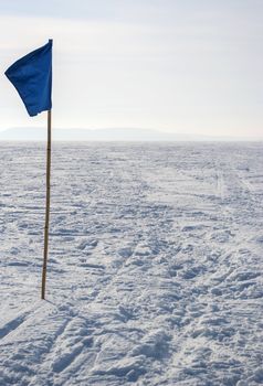 flag in the snow in an open space