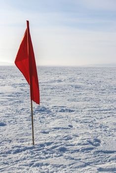 flag in the snow in an open space