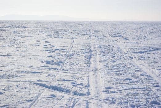 Footprints in the backdrop of snow-covered field