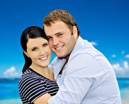 Beautiful young couple with sea and sky in the background