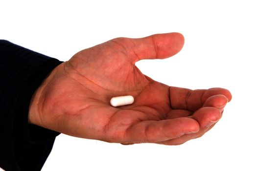 Mans hand holding a pill capsule of medicine.