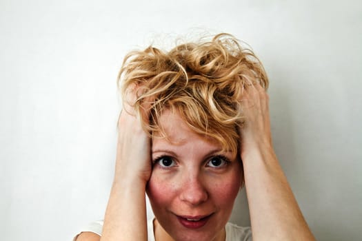 Young blond girl with morning look and mixed hairs on a white background