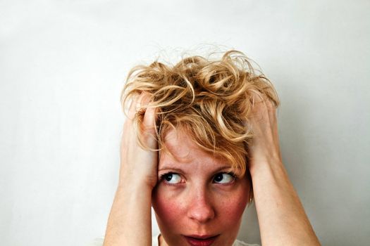 Young blond girl with morning look and mixed hairs on a white background