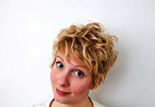 Young blond girl with morning look and mixed hairs on a white background