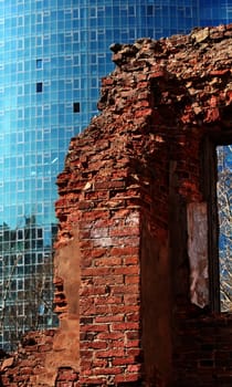 ruins on the background of modern skyscrapers