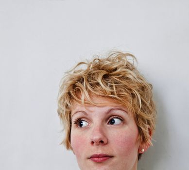 Young blond girl with morning look and mixed hairs on a white background