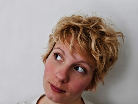 Young blond girl with morning look and mixed hairs on a white background